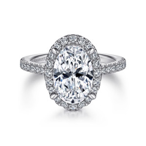 Gabriel & Co. ER14725O8W44JJ 14 karat white gold Classic engagement ring, front view of an oval halo of small round diamonds with claw prongs rising through it