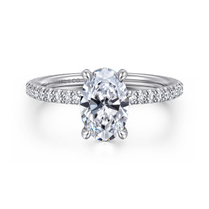 Gabriel & Co. ER14914O6W44JJ 14 karat white gold Classic engagement ring, front view of an oval center with a slim band of round diamonds along the shoulders