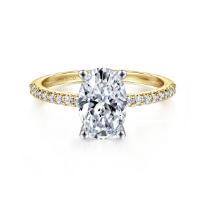 Gabriel & Co. ER14918O6M44JJ 14 karat white and yellow gold Classic engagement ring, front view of an oval center held by four slim prongs above stones along the shoulders