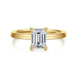 Gabriel & Co. ER14982E4Y4JJJ 14 karat yellow gold Classic engagement ring, front view of an emerald cut center in four tapered claw prongs on a smooth band