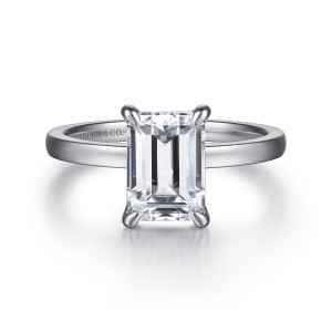 Gabriel & Co. ER14982E8W4JJJ 14 karat white gold Classic engagement ring, front view of the emerald cut center held by curved claws on a flat faced band