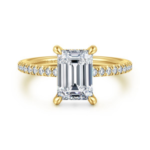 Gabriel & Co. ER14987E8Y44JJ 14 karat yellow gold Classic engagement ring, front view of an emerald cut center in four corner prongs with small diamonds along the shoulders