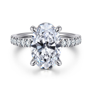 Gabriel & Co. ER14987O16W44JJ 14 karat white gold Classic engagement ring, front view of an oval center in four teardrop shaped prongs above a band of round diamonds