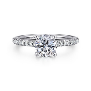 Gabriel & Co. ER14987R4W44JJ 14 karat white gold Classic engagement ring, front view of a round center in tapered prongs above a line of small diamonds on the shoulders