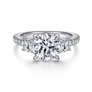 Gabriel & Co. ER15002R8W83JJ 18 karat white gold Contemporary engagement ring, front view of a round center between two round stones with small diamonds down each shoulder