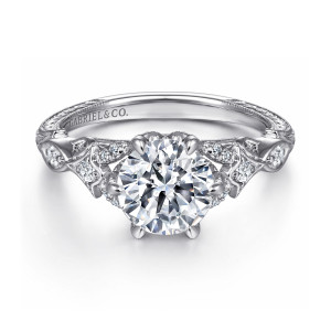 Gabriel & Co. ER15027R6W44JJ 14 karat white gold Victorian engagement ring, front view of a round center in prongs above leaf shaped diamond frames on the shoulders