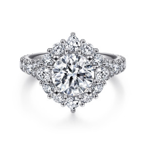 Gabriel & Co. ER15046R8PT4JJ platinum Starlight engagement ring, front view of the round center inside a halo with pointed stones at the top and bottom