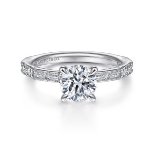 Gabriel & Co. ER15204R4PT4JJ platinum Art Deco engagement ring, front view of a round center between milgrain framed baguettes on a slim band