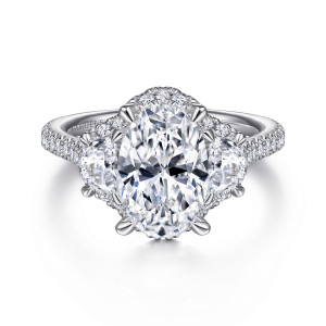 Gabriel & Co. ER15330O8W44JJ 14 karat white gold Contemporary engagement ring, front view of an oval center with a halo and a half moon stone on each side