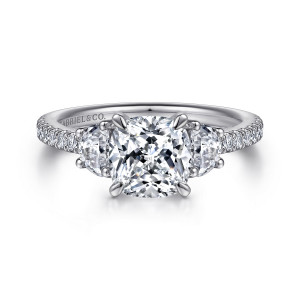 Gabriel & Co. ER15341C8W44JJ 14 karat white gold Contemporary engagement ring, front view of a cushion center between two half moon stones with round stones on the band shoulders