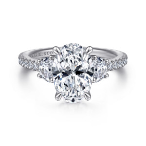 Gabriel & Co. ER15341O8W44JJ 14 karat white gold Contemporary engagement ring, front view of an oval center with a half moon side stone on either side of it