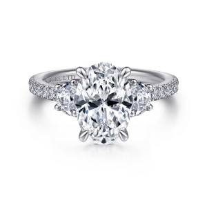 Gabriel & Co. ER15341O8W83JJ 18 karat white gold Contemporary engagement ring, front view of an oval center between half moon side stones with pave on the shoulders