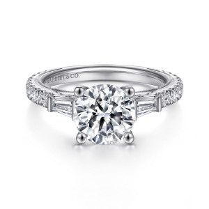 Gabriel & Co. ER15353R6W44JJ 14 karat white gold Contemporary engagement ring, front view of a round center between tapering step cut stones, small diamonds along the band