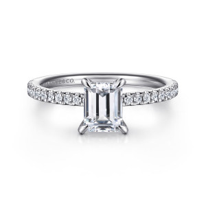 Gabriel & Co. ER15525E4W44JJ 14 karat white gold Classic engagement ring, front view of the emerald cut center with round stones lining the band on both sides