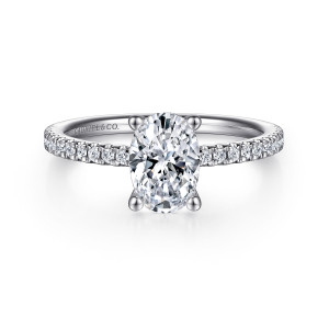 Gabriel & Co. ER15525O4W44JJ 14 karat white gold Classic engagement ring, front view of an oval center in four rounded prongs flanked by small round stones