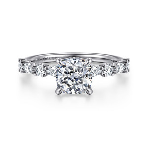 Gabriel & Co. ER15607C6W44JJ 14 karat white gold Contemporary engagement ring, front view of a cushion cut center flanked by alternating round and elongated diamonds on the band