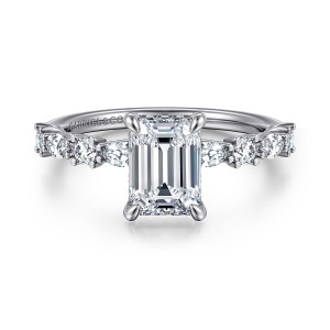 Gabriel & Co. ER15607E6W44JJ 14 karat white gold Contemporary engagement ring, front view of an emerald cut center with round and elongated diamonds along each shoulder