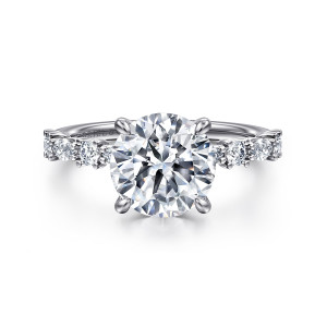 Gabriel & Co. ER15607R10W44JJ 14 karat white gold Contemporary engagement ring, front view of a round center between spaced round and elongated diamonds on the shoulders