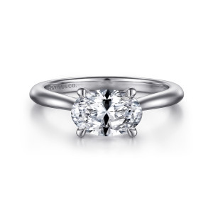 Gabriel & Co. ER15618O6W4JJJ 14 karat white gold Classic engagement ring, front view of a sideways oval center held by four claws on a smooth tapering band