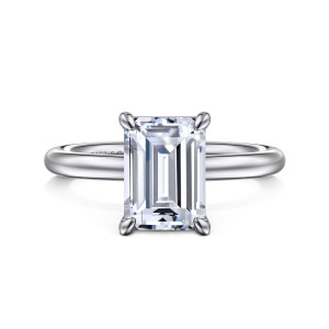 Gabriel & Co. ER15619E10W4JJJ 14 karat white gold Classic engagement ring, front view of an emerald cut center in four pointed claw prongs on a smooth band