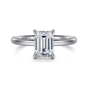 Gabriel & Co. ER15619E6W4JJJ 14 karat white gold Classic engagement ring, front view of an emerald cut center held by four tapered claw prongs on a smooth band