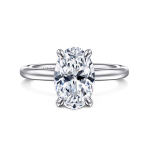 Gabriel & Co. ER15619O10W4JJJ 14 karat white gold Classic engagement ring, front view of an oval center gripped by four claw prongs above a smooth band