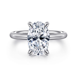 Gabriel & Co. ER15619O12W4JJJ 14 karat white gold Classic engagement ring, front view of an oval center held by four leaf tipped prongs above a plain rounded band