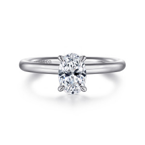 Gabriel & Co. ER15619O4PTJJJ platinum Classic engagement ring, front view of an oval center gripped by slender pointed claws on a smooth rounded band