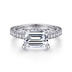 Gabriel & Co. ER15621E10W44JJ 14 karat white gold Contemporary engagement ring, front view of an emerald cut center lying east to west above a band of small round diamonds