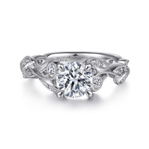Gabriel & Co. ER15626R4PT4JJ platinum Floral Nouveau engagement ring, front view of a round center flanked by leaf frames and small bezel stones on a vine band