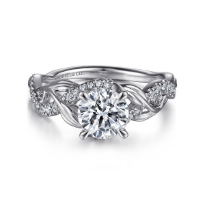 Gabriel & Co. ER15759R4W44JJ 14 karat white gold Floral Nouveau engagement ring, front view of a round center with a curved arc of small stones and leafy twisting shoulders