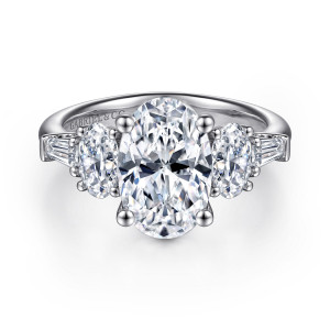 Gabriel & Co. ER15816O10W44JJ 14 karat white gold Classic engagement ring, front view of an oval center with an oval and a tapered baguette on each side