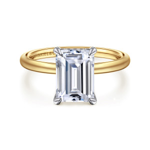 Gabriel & Co. ER15972E10M44JJ 14 karat white and yellow gold Classic engagement ring, front view of an emerald cut center held by four pointed claw prongs on a smooth plain band
