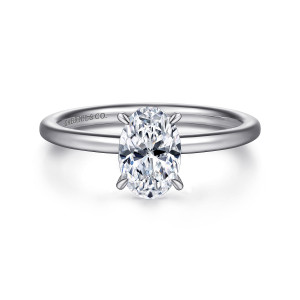 Gabriel & Co. ER15972O4PT4JJ platinum Classic engagement ring, front view of an oval center held by four slim pointed prongs on a thin smooth band
