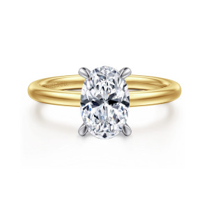 Gabriel & Co. ER15972O6M44JJ 14 karat white and yellow gold Classic engagement ring, front view of an oval center gripped by four tapered prongs above a smooth, rounded band