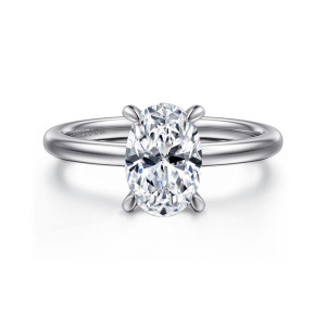Gabriel & Co. ER15972O6W84JJ 18 karat white gold Classic engagement ring, front view of an oval center held by four prongs with rounded tips over a plain band