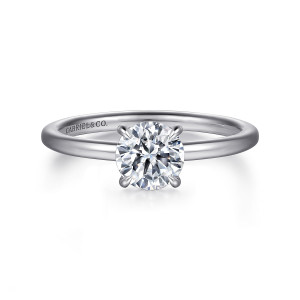 Gabriel & Co. ER15972R4W44JJ 14 karat white gold Classic engagement ring, front view of the round center held by four rounded claws on a smooth slim band