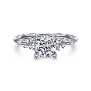 Gabriel & Co. ER15973C6W84JJ 18 karat white gold Starlight engagement ring, front view of a cushion center between loose clusters of small round diamonds on each shoulder