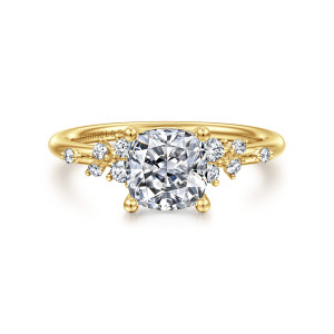 Gabriel & Co. ER15973C6Y44JJ 14 karat yellow gold Starlight engagement ring, front view of the cushion center with ball tipped prongs and staggered diamond clusters on both shoulders