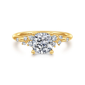 Gabriel & Co. ER15973C6Y84JJ 18 karat yellow gold Starlight engagement ring, front view of a cushion shaped center with clusters of small round stones on both shoulders