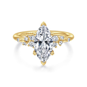 Gabriel & Co. ER15973M6Y44JJ 14 karat yellow gold Starlight engagement ring, front view of a marquise center with pointed end prongs and scattered round diamonds on each shoulder