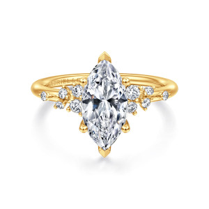 Gabriel & Co. ER15973M6Y84JJ 18 karat yellow gold Starlight engagement ring, front view of a marquise center with a pointed prong at each tip and scattered stones beside it