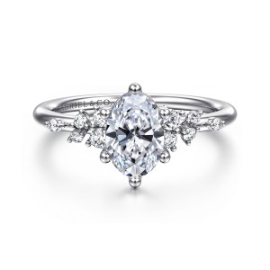 Gabriel & Co. ER15973O4W44JJ 14 karat white gold Starlight engagement ring, front view of an oval center on ball tipped claws with scattered diamonds on both shoulders