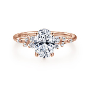 Gabriel & Co. ER15973O6K44JJ 14 karat rose gold Starlight engagement ring, front view of an oval center between scattered clusters of small round diamonds on a slender band