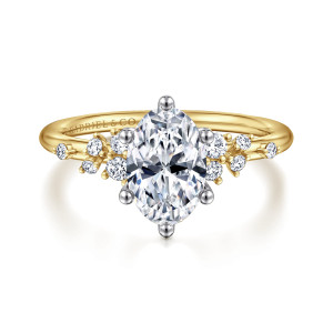 Gabriel & Co. ER15973O6M44JJ 14 karat white and yellow gold Starlight engagement ring, front view of an oval center with ball tipped prongs and scattered round diamonds on both shoulders