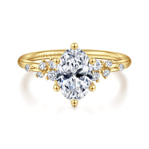 Gabriel & Co. ER15973O6Y44JJ 14 karat yellow gold Starlight engagement ring, front view of an oval center with six ball tipped prongs and scattered stones on both shoulders