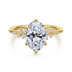 Gabriel & Co. ER15973O8Y44JJ 14 karat yellow gold Starlight engagement ring, front view of an oval center between loose clusters of small round diamonds on a thin band