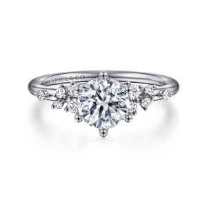 Gabriel & Co. ER15973R4PT4JJ platinum Starlight engagement ring, front view of the round center in six ball tipped prongs with diamond groups at each side