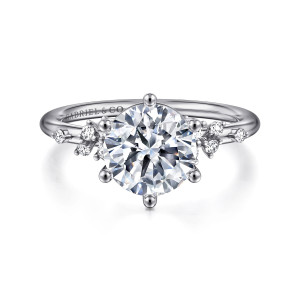 Gabriel & Co. ER15973R8W44JJ 14 karat white gold Starlight engagement ring, front view of a round center in ball tipped prongs with scattered small diamonds at the shoulders