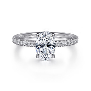 Gabriel & Co. ER16058O6W44JJ 14 karat white gold Classic engagement ring, front view of an oval center held by claw prongs above stones on both shoulders